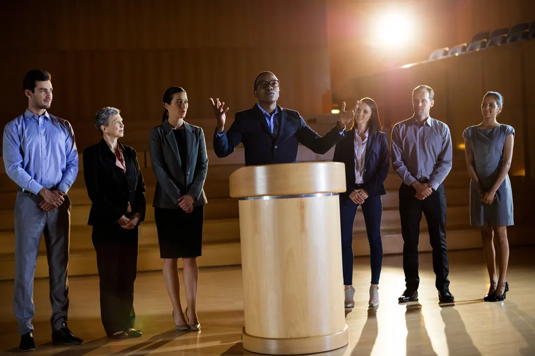 Speaker at podium presenting award ceremony Speaker at podium presenting award ceremony